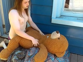 Sissy boy plumbing her teddy cub outside